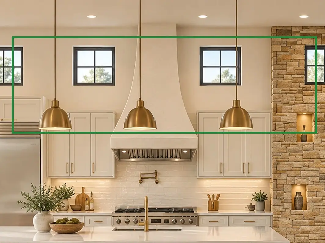 04 · the approved photo, boxed in green where it shows what belongs there: A2.1 notes a flat 12-ft ceiling. The approved kitchen photo (04) has upper cabinets either side of the hood, three brass pendants, and small square windows above the cabinets, as A2.2's kitchen wall 3 draws them.